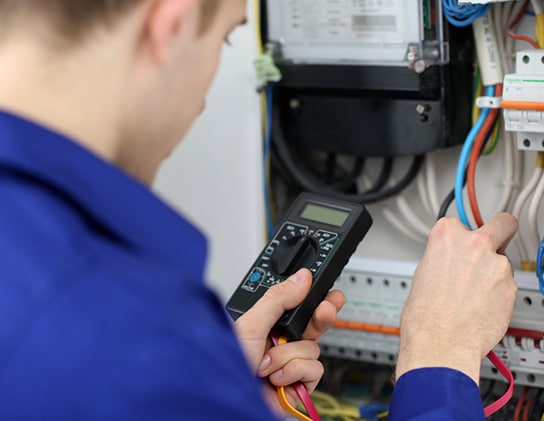 Electrician Measuring Voltage in Fuse Board — Expert Trade Services in Burleigh Heads, QLD