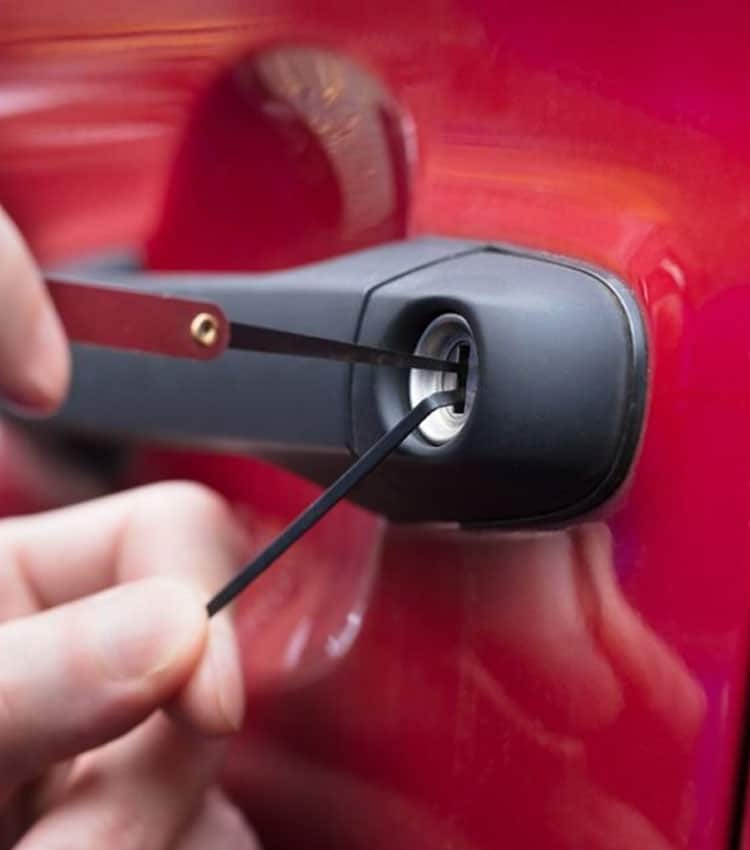 Opening Red Car's Door With Lockpicker — Expert Trade Services in Burleigh Heads, QLD