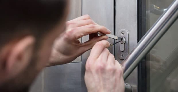 Close-up Photo Of A Man Opening Door With Lockpicker — Plumbers in Southport, QLD