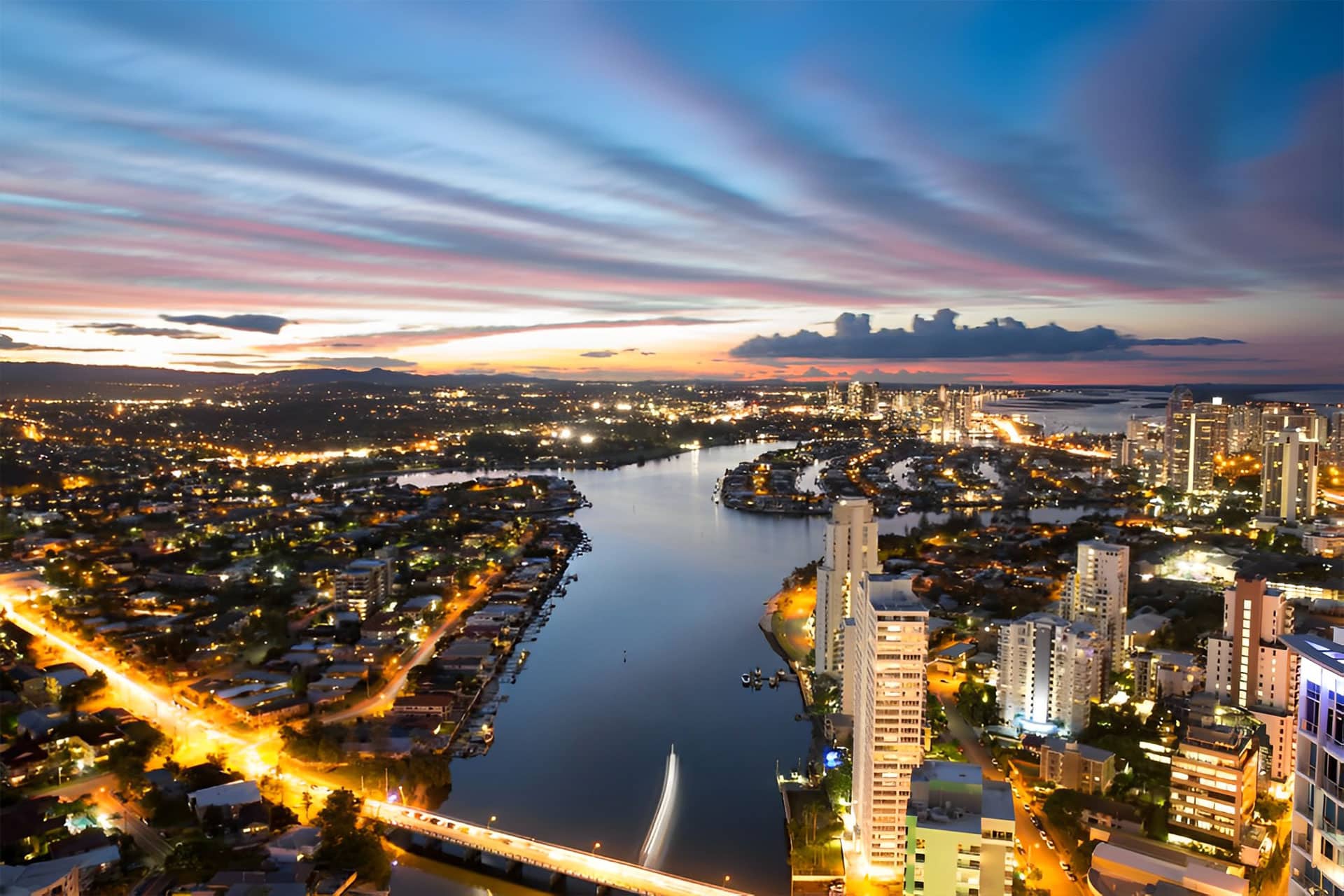 Colorful Sunset Over Suburbs — Plumbers in Biggera Waters, QLD
