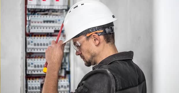 Electrical Technician Working In A Switchboard — Electricians in Surfers Paradise, QLD