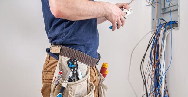 Electrician Examines Cable Connection — Locksmiths in Labrador, QLD
