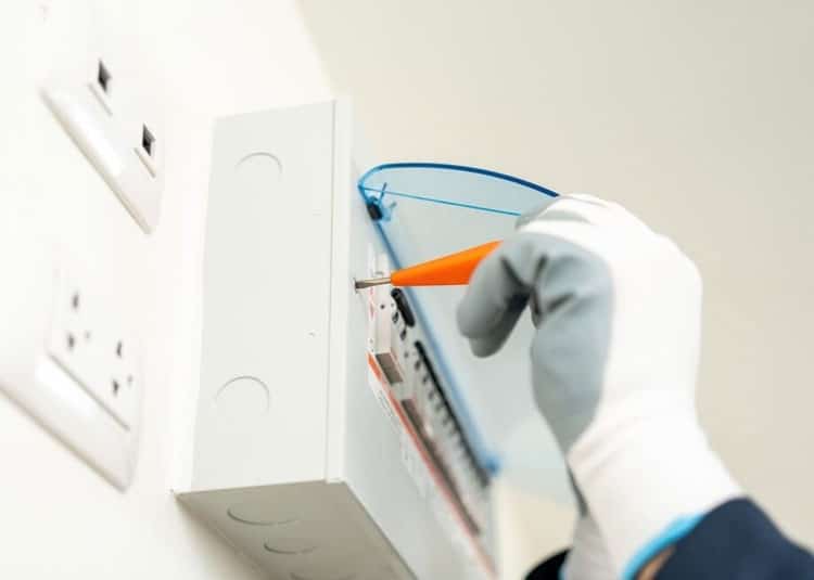 Electrician Working At A Home Repairing With Screwdriver— Expert Trade Services in Burleigh Heads, QLD