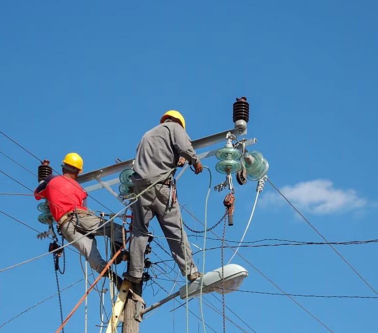 Lineman On Pole Low Angle Shot Repairing — Electricians in Broadbeach Waters, QLD