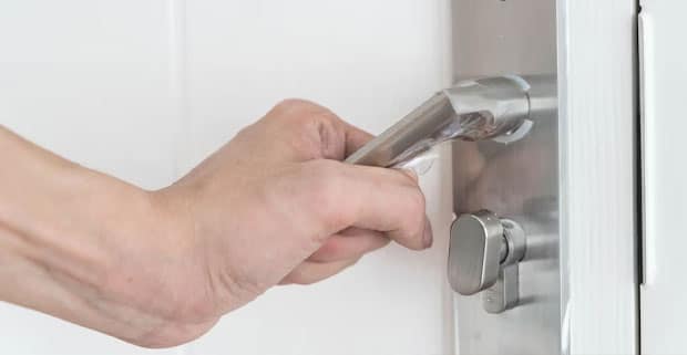 Man Testing Newly Installed Door Handle — Locksmiths in Burleigh Waters, QLD
