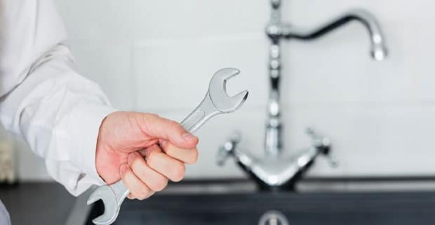 Plumber Holding Wrench — Locksmiths in Surfers Paradise, QLD