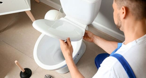 Plumber Installing Toilet — Plumbers in Robina, QLD