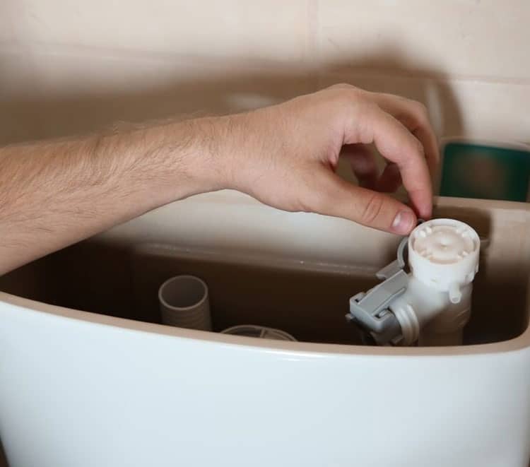 Professional Plumber Repairing Toilet — Plumbers in Broadbeach, QLD