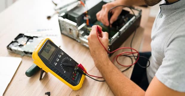 Technician Using Multimeter To Measure Voltage — Electricians in Broadbeach Waters, QLD