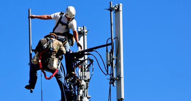 Technicians Working On Telecommunication Tower — Plumbers in Broadbeach, QLD