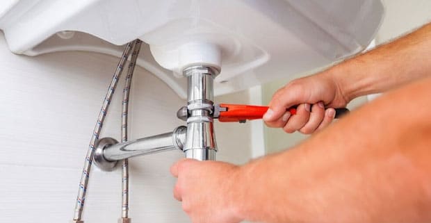 Wench Holding By A Plumber — Expert Trade Services in Burleigh Heads, QLD