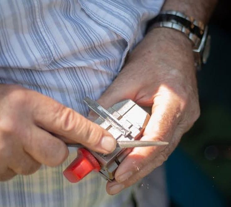 Filing Car Key With A Blade — Locksmiths in Burleigh Waters, QLD