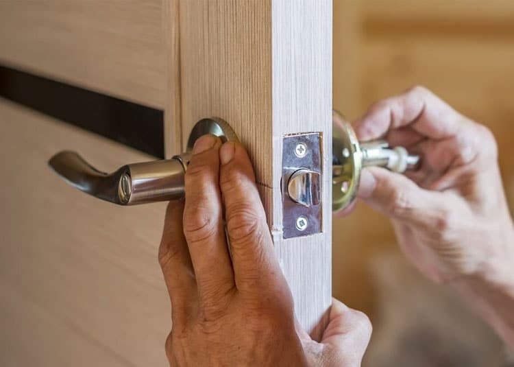 Man Installing A Door Knob — Expert Trade Services in Burleigh Heads, QLD