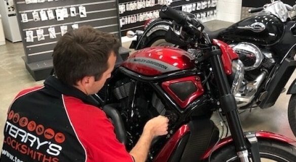 Man Testing Key to the Motorcycle — Expert Trade Services in Burleigh Heads, QLD