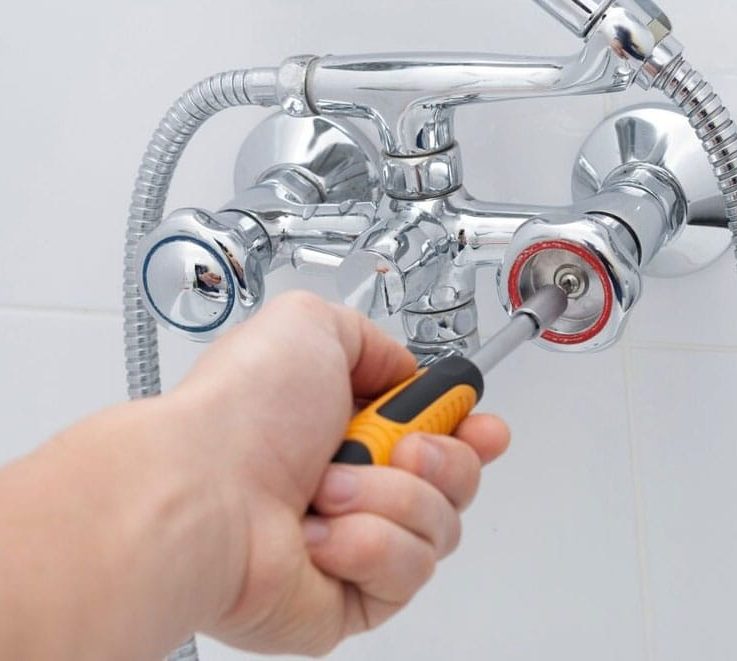 Plumber Repairs The Faucet In The Bathroom — Plumbers in Burleigh Heads, QLD